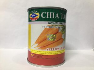A 100-gram tin container of Chia Tai brand F1 Hybrid Carrot seeds named "Yellow Rocket," featuring an image of bright orange carrots and a holographic security seal.